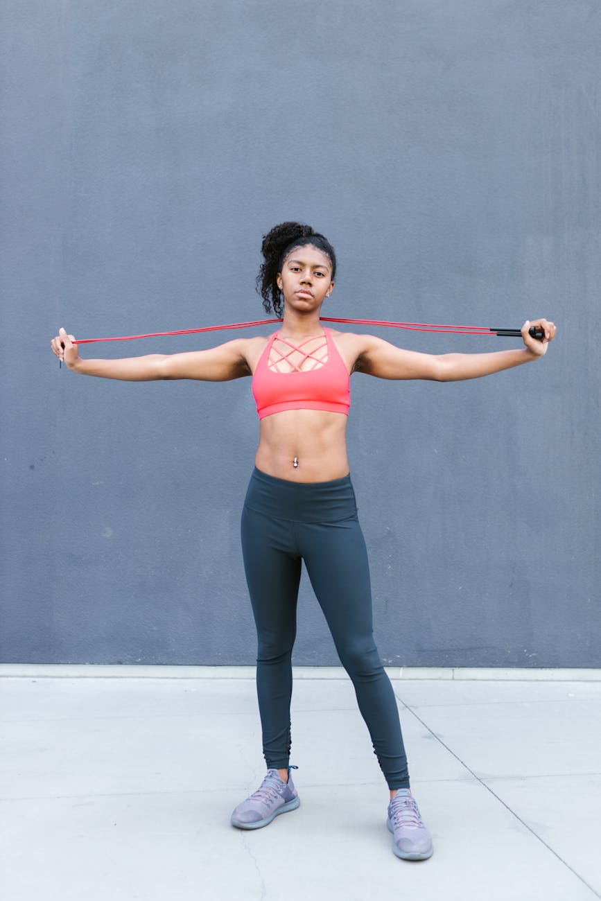 woman in red sports bra holding a jump rope