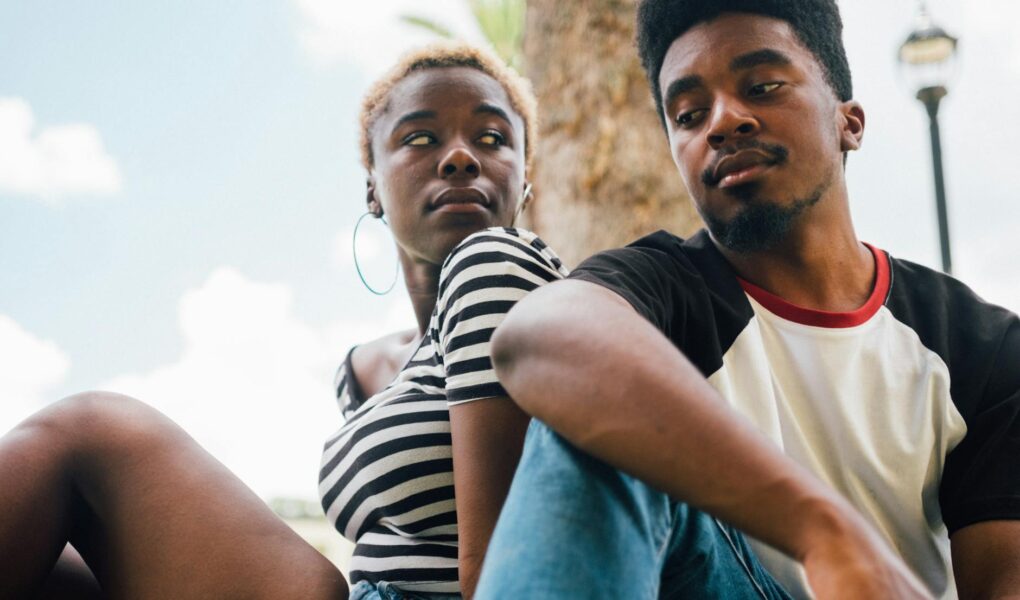 man sitting beside woman