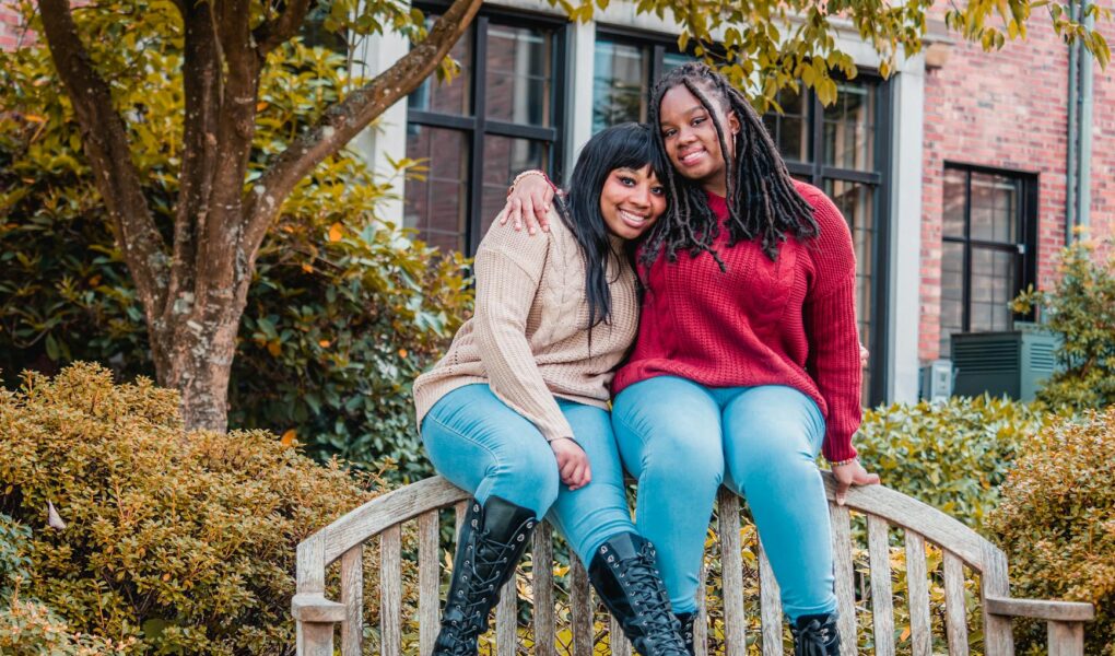 african american ladies sitting on top of wooden bench