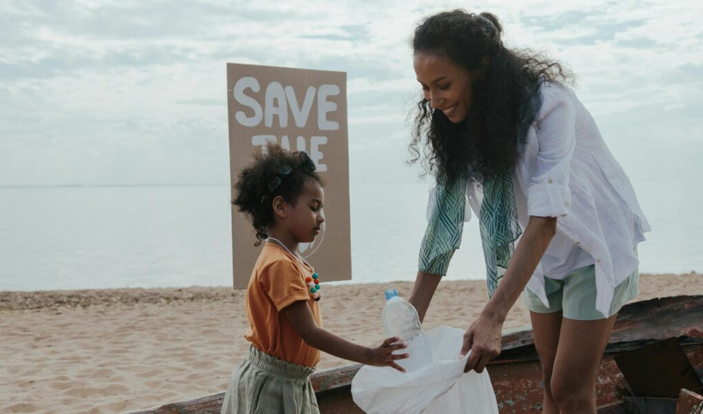 two women cleaning at the beach